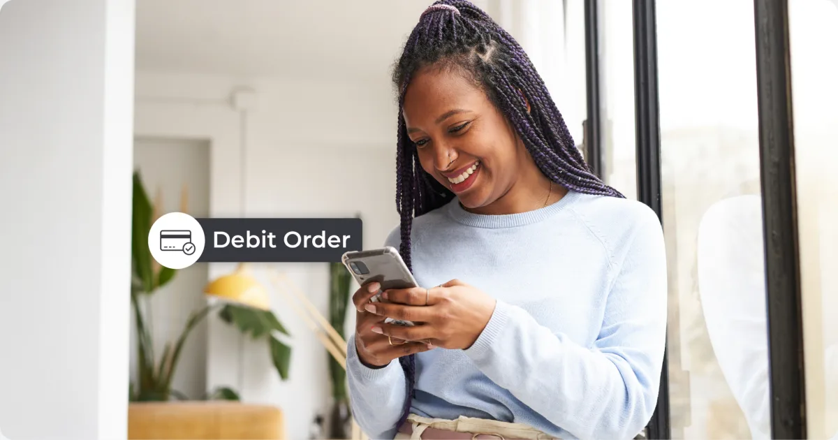 Woman smiling at her phone with a Debit Order notification, setting up automatic TFSA contributions on Kastelo