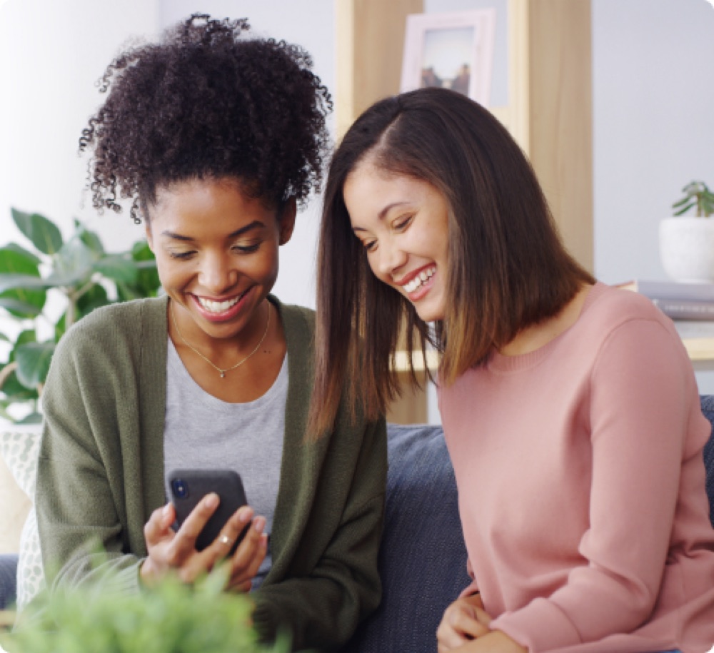 Two people reviewing a personalised investment plan on a phone